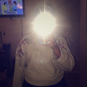 Hoodie with floral design on shoulders.